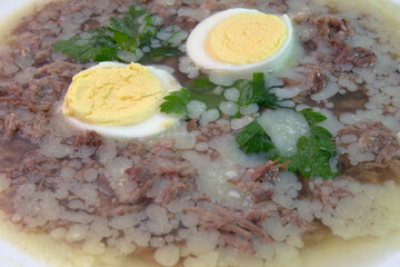 aspic with meat, eggs and fresh parsley, made with thick and rich nutritious bone broth, frozen. closeup