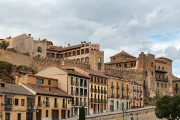 Fototapeta premium Wall of Segovia in an area that is confused with the houses