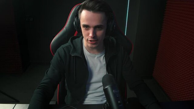 Emotional gamer in headphones
streams online and swears because of the defeat in the round. A male gamer is emotionally annoyed because of an unsuccessful game.