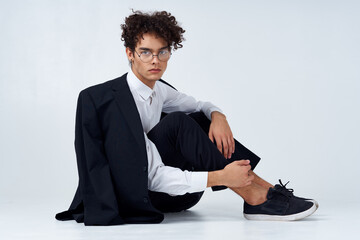 curly haired man in classic suit model studio photography sneakers