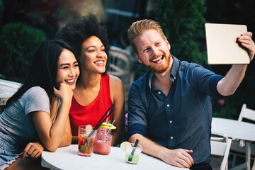 Young friends having a great time together. Group of people talking and smiling.
