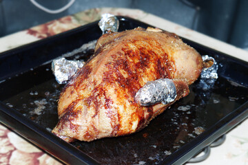 roast goose with ruddy crust, on baking sheet, puffed and curvy, stuffed with apples, ready for cutting into chunks for the Christmas holiday table. with clipping path