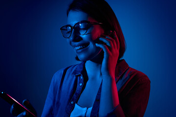 Cheerful woman listening to music in true wireless earphones