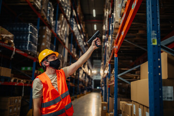 Man with bar-code reader in warehouse