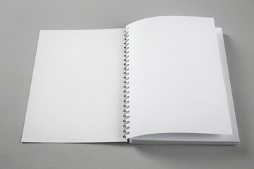 Open blank notebook on grey background. Mockup for design