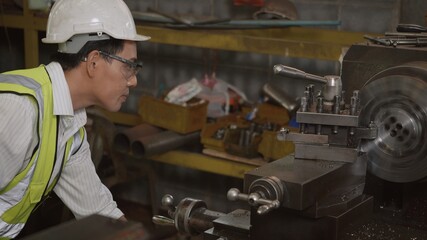 Asian professional mechanical engineer or operation man wearing uniform goggles safety working on...