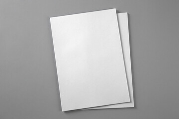 Blank brochures on grey background, top view. Mockup for design
