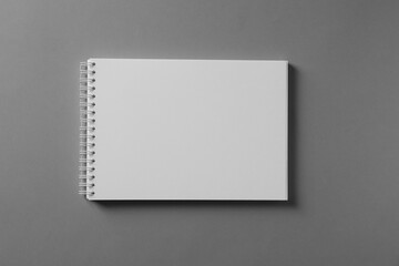 Blank notebook on light grey background, top view. Mockup for design