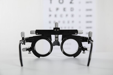 Trial frame on light background, closeup. Ophthalmologist tool