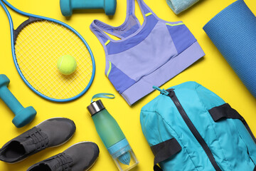 Flat lay composition with sports equipment on yellow background © New Africa