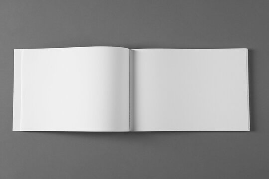 Open blank brochure on light grey background, top view