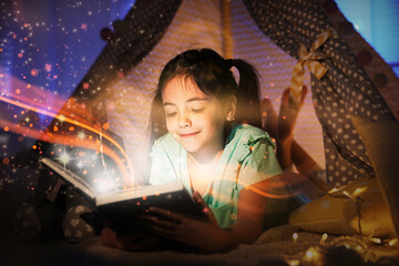 Little girl reading fairy tale in play tent at home © New Africa