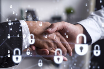 Handshake of two businesspeople who are negotiated the project to protect cyber security of...
