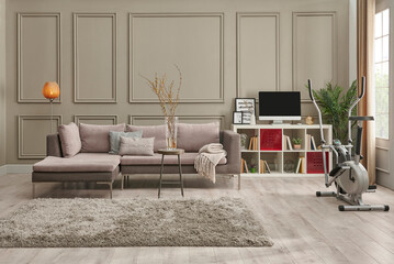 Grey sofa in the brown wall, home decoration working table carpet and chair style.