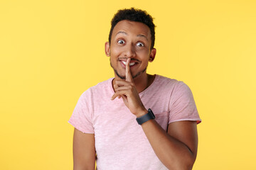 Fototapeta na wymiar Handsome african american young man show keep silent gesture over yellow background.