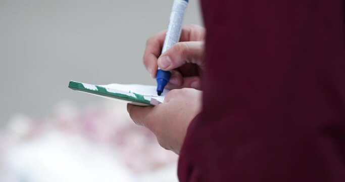 Image Of A Hand Holding Pentel Pen Marker Writing Use For Labeling His Merchandise At Market In Leiria, Portugal. - Close Up Shot
