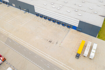 Aerial view of goods warehouse. Logistics delivery  center in industrial city zone from above....