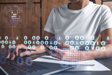Hands of woman hr specialist is typing the keyboard in the internet to find the best candidates to create international network in recruitment process. Casual wear. Social media hologram icons.