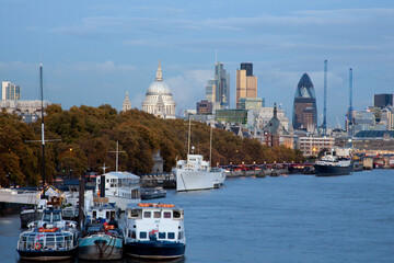 View of the River Thames in London with boats in the foreground and St Paul's Cathedral in the background