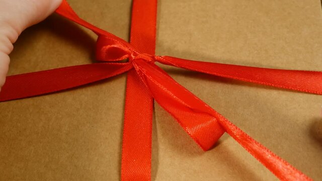 Gift parcel box with ribbon red bow, brown carton parcel, surprise