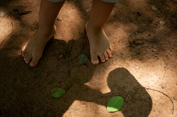 children's barefoot on ground