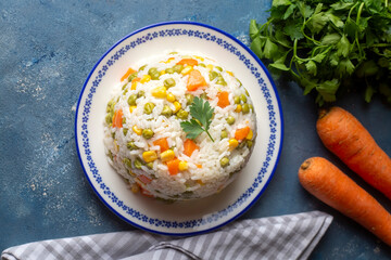 Delicious vegetable rice pilaf with green peas, carrots and sweet corn