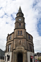Fototapeta premium Tower & Clock on Old Circular Stone Building seen from Below 