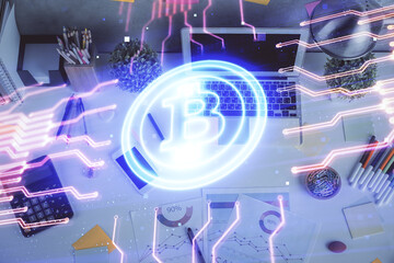 Blockchain theme hologram drawings over computer on the desktop background. Top view. Multi...