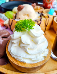 Whipped cream with  parsley leafs in wood cup and honey toast.