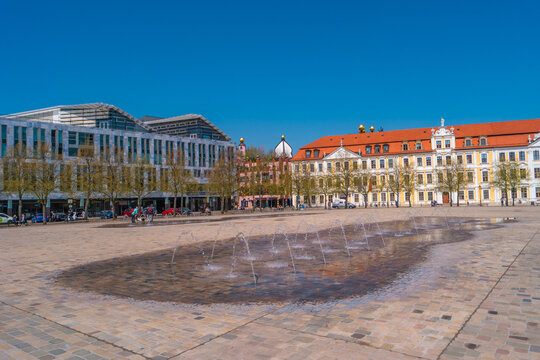 View over major square with fountains in Magdeburg by Cathedral and Government Office, at sunny day and blue sky.