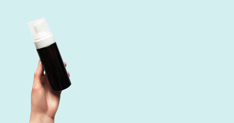 Woman hand holding facial cleanser isolated realistic 3d vector illustration. Beauty skincare cosmetic product  on blue background horizontal banner