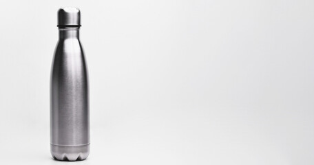 Stainless thermos water bottle, isolated on white background. Silver color. Blank stainless steel double wall workout bottle, wide banner with space for text right side. 