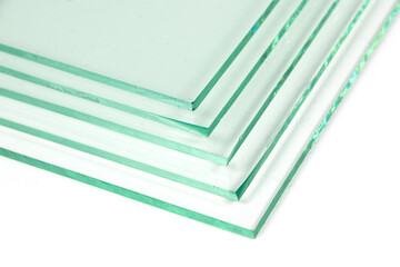 Sheets of Factory manufacturing tempered clear float glass panels cut to size. White background