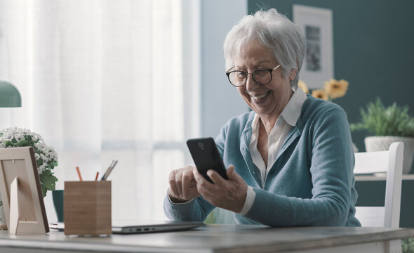 Smiling Senior Lady Using Her Smartphone