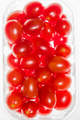 Cocktail tomatoes in plastic bag on white background. Wiev from above.