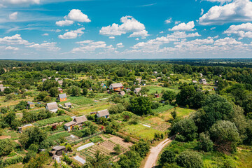 Fototapeta na wymiar Aerial View Of Small Town, Village Cityscape Skyline In Summer Day. Residential District, Houses And Vegetable Garden Beds In Bird's-eye View
