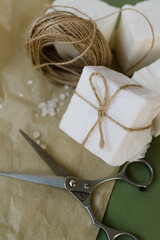 handmade soap beautifully packaged scissors and twine on the table