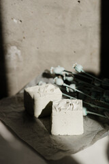 handmade soap in white on the background of the wall and flowers
