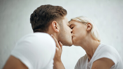 young blonde woman kissing with boyfriend