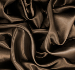 Smooth elegant brown silk or satin texture as abstract background. Luxurious background design....