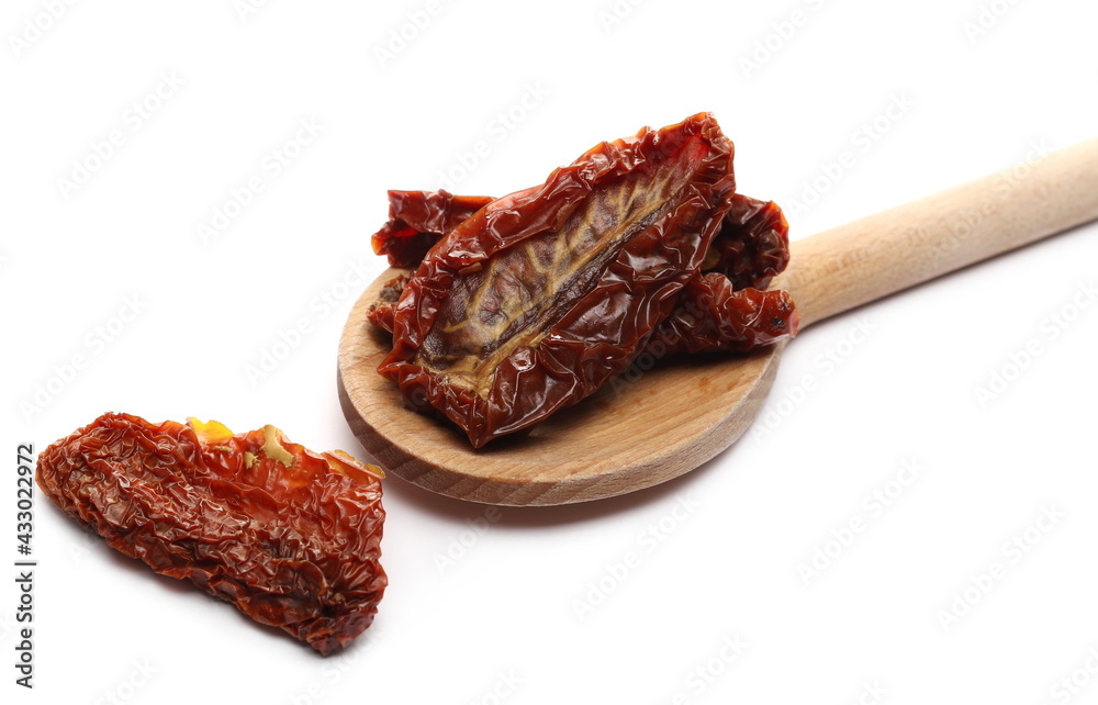 Wall mural sun dried tomatoes in wooden spoon isolated on white background