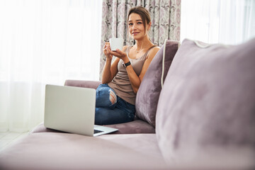 Positive delighted female person enjoying her tea