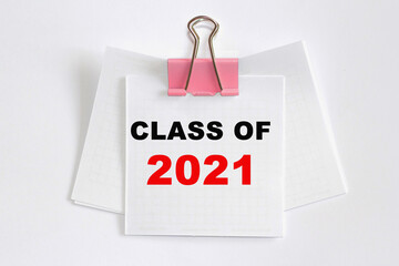 CLASS OF 2021 . A small piece of paper clamped by binder clip to a wire . The concept of business and education.