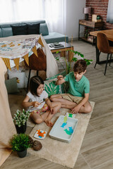 Children camping at home playing fishing game in the living room © David Pereiras