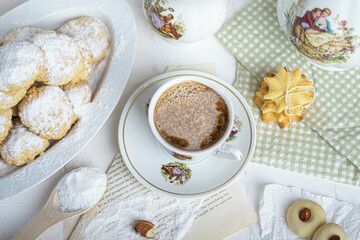 My sister spill the milk on chocolate hot drink to prepare breakfast with Eid Cookies which is called Kahk.
