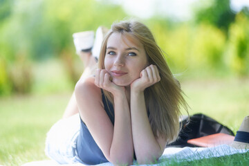 Portrait of a young woman enjoying the sunshine in the garden