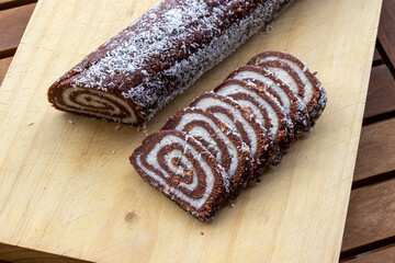 Classic Hungarian coconut roll served on a wooden board