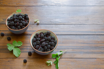 blackberries in bowls on a wooden table