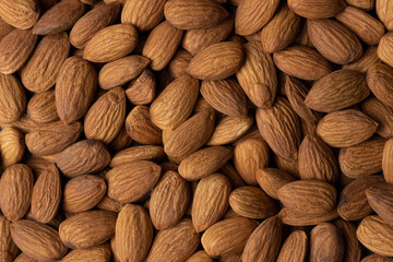 Pile of peeled raw almonds as a background