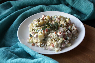 Salad of potatoes, sausage, peas, carrots and cucumbers. Olivier.